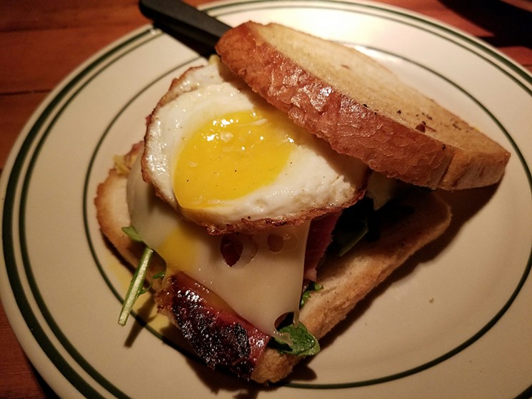 The Pig and Swiss sandwich at the Deli Tavern features crispy prosciutto, a fried egg, and spicy mustard. - PATRICIA ESCARCEGA