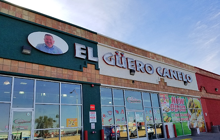 The storefront of the Phoenix location of El Guero Canelo, which features the friendly-looking image of its owner, Daniel Contreras. - PATRICIA ESCARCEGA