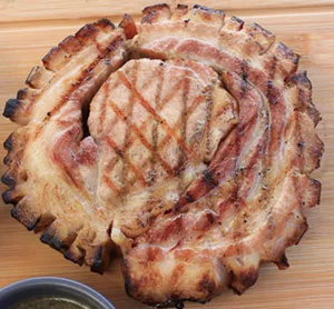 Pork belly wrapped around a boneless pork chop is Starlite's take on a Puerto Rican can-can steak. - CHRIS MALLOY