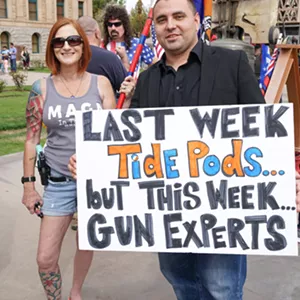 Some armed Trump supporters mocked the March for Our Lives participants. Note the proper display of the flag tattooed on her arm. - PATRICK BRYANT