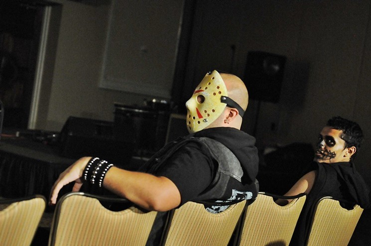 A Mad Monster Arizona attendee dressed as Jason Voorhees chills out. - BENJAMIN LEATHERMAN