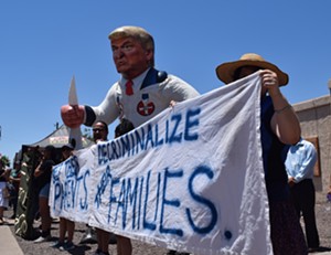 Demonstrators protested outside of a Southwest Key shelter for migrant kids in Phoenix in June as First Lady Melania Trump visited the shelter. - JOSEPH FLAHERTY
