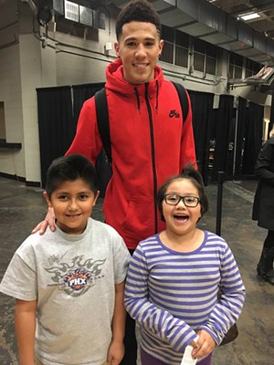 Booker poses with two Mexican-American fans, Hugo and Kassandra Robledo. - JUANA ROBLEDO