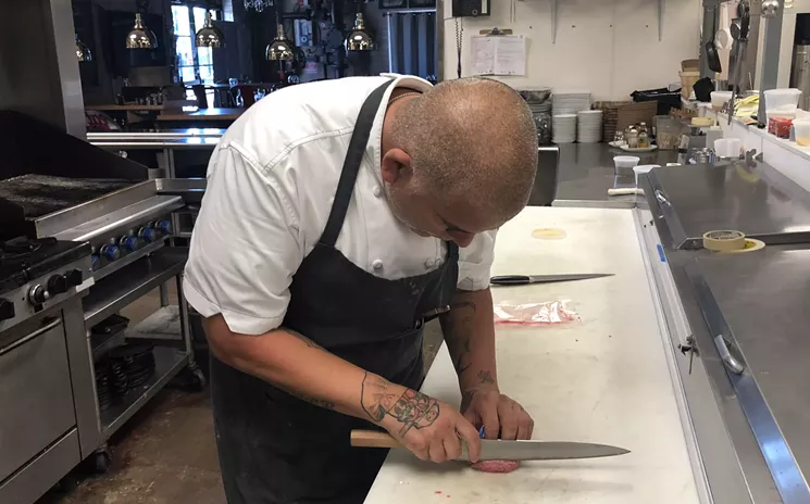 Duarte slices a slip of meat from a cut of Japanese wagyu plate - CHRIS MALLOY