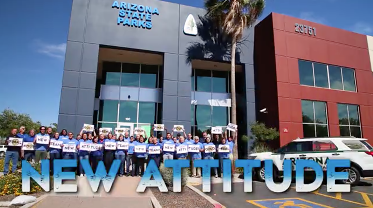 In a still from Arizona State Parks' video submission for the Gold Medal award, staff pose outside the agency's north Phoenix headquarters. - ARIZONA STATE PARKS