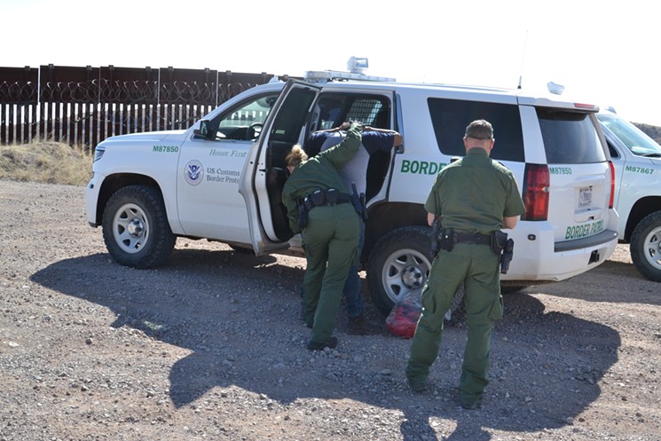 Border Patrol arrested a migrant who had just jumped over the border fence near Nogales on Tuesday, February 12. - STEVEN HSIEH