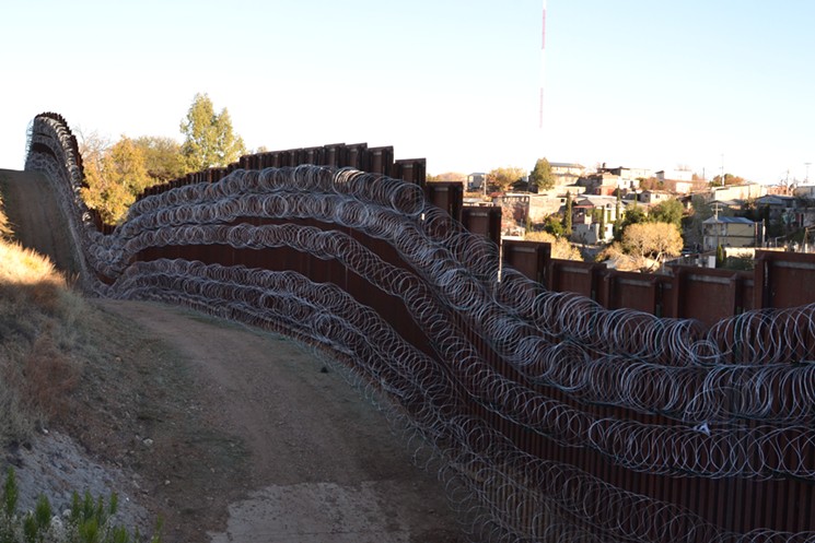 A view of Nogales, Sonora, beyond the concertina-wire enforced border fence. - STEVEN HSIEH