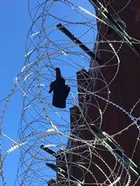 According to Nogales resident Carlos Santa Cruz, a migrant got caught on the wire shortly after it was installed, causing him to lose a glove. - STEVEN HSIEH