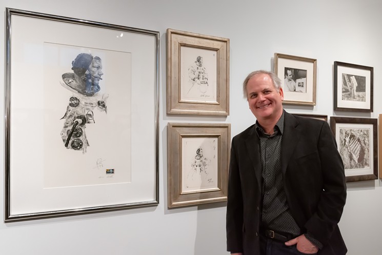 Paul Calle's son Chris with some of his dad's artwork at SMoW. - TIM FUCHS