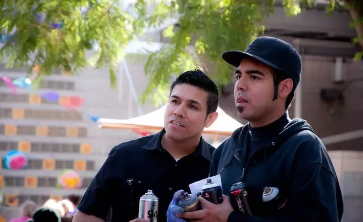Such (left) and Champ Styles pause from live painting during a festival at Mesa Arts Center. - JASMINE MAGANDA