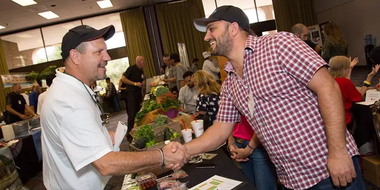 Two folks meeting at the Farmer + Chef Connection, now the Arizona Good Food Expo. - LOCAL FIRST ARIZONA