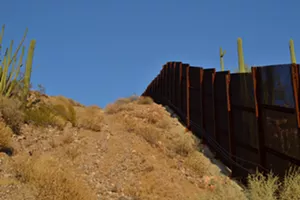 Part of the wire mesh fence crosses a steep hill that is extremely difficult to cross on foot. - ELIZABETH WHITMAN