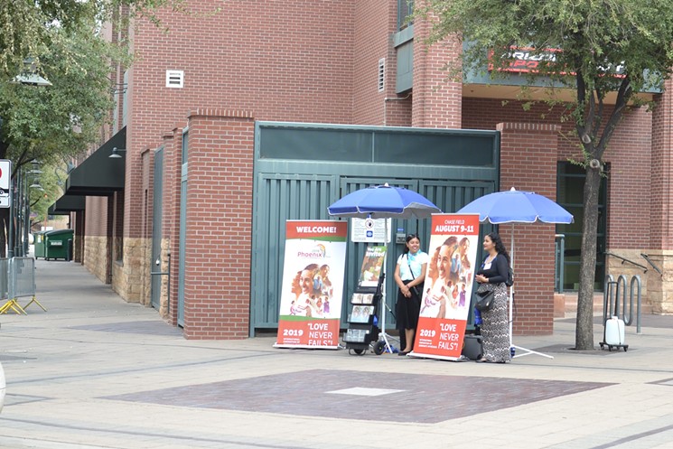 Two Jehovah's Witnesses outside Chase Field on August 9, 2019. - ELIZABETH WHITMAN