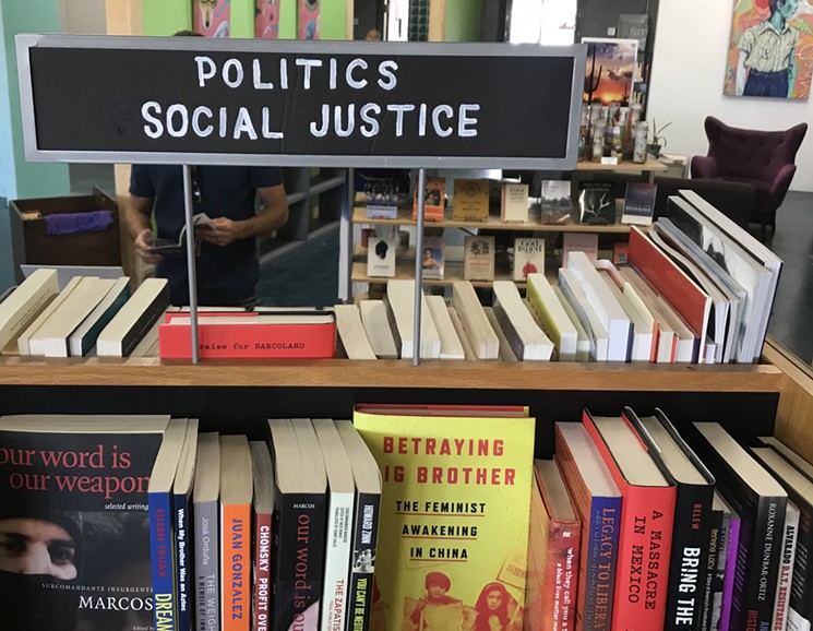 Checking out the social justice section at Palabras Bilingual Bookstore. - LYNN TRIMBLE
