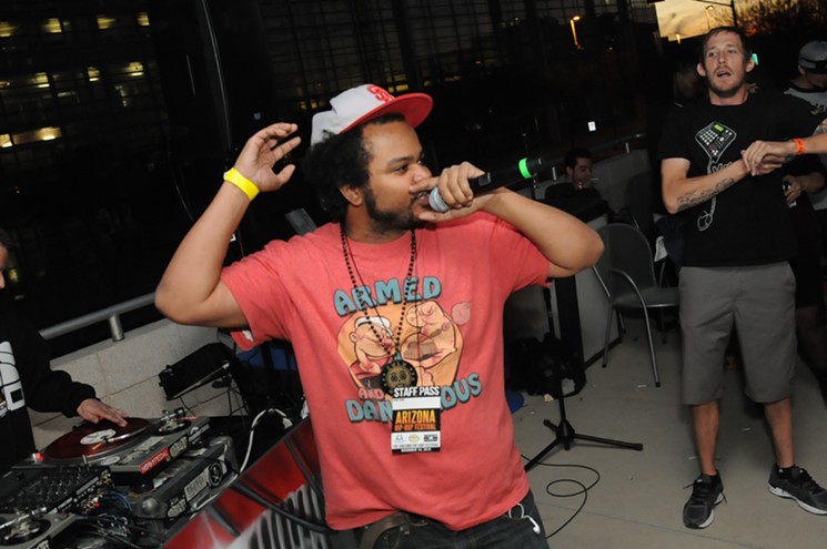 Local rapper RoQ'y TyRaiD performs at the Fresh Out the Oven stage on Comerica Theatre's second-floor patio during the Arizona Hip-Hop Festival 2015. - BENJAMIN LEATHERMAN