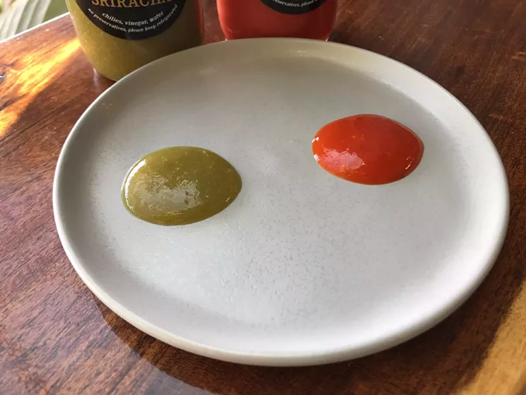 The Clever Koi blends two great hot sauces. The green is a fiery jalapeno, the red a Fresno that nods to Sriracha. - CHRIS MALLOY