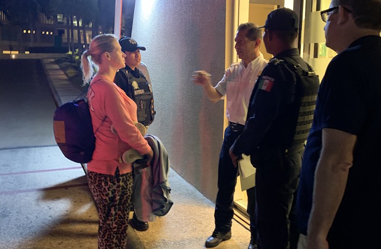 Emily Lopatofsky (left) speaking with police outside the hotel in Cancún where her family was staying - GLADYS JAHN