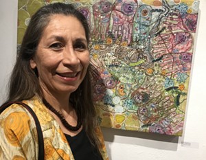 Monica Aissa Martinez with her artwork featured in "A City, Modified." - LYNN TRIMBLE