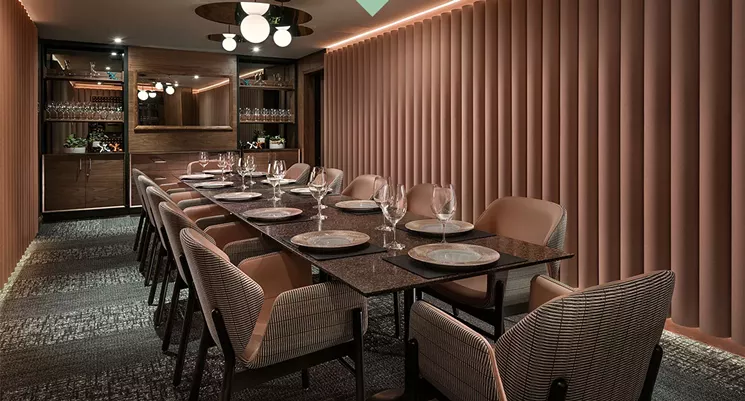 The Rosie Room at ZuZu Restaurant has a TV for presentations and photo slideshows that doubles as a mirror when not in use. - ZUZU RESTAURANT