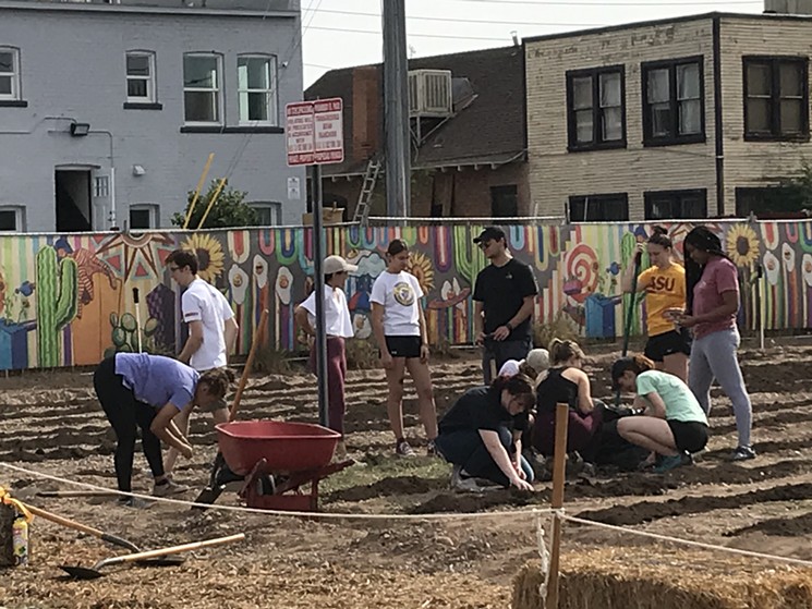 Local students gardening at the current Roosevelt Growhouse location. - LYNN TRIMBLE