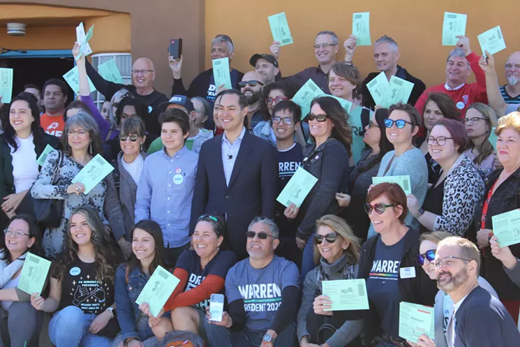 Former presidential candidate Julián Castro poses with Elizabeth Warren supporters at an early voting event at Phoenix's El Portal restaurant. - ALI SWENSON