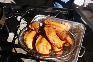 A basketful of chicken tinga quesadillas cool off after being fried in oil. - JOSÉ-IGNACIO CASTAÑEDA