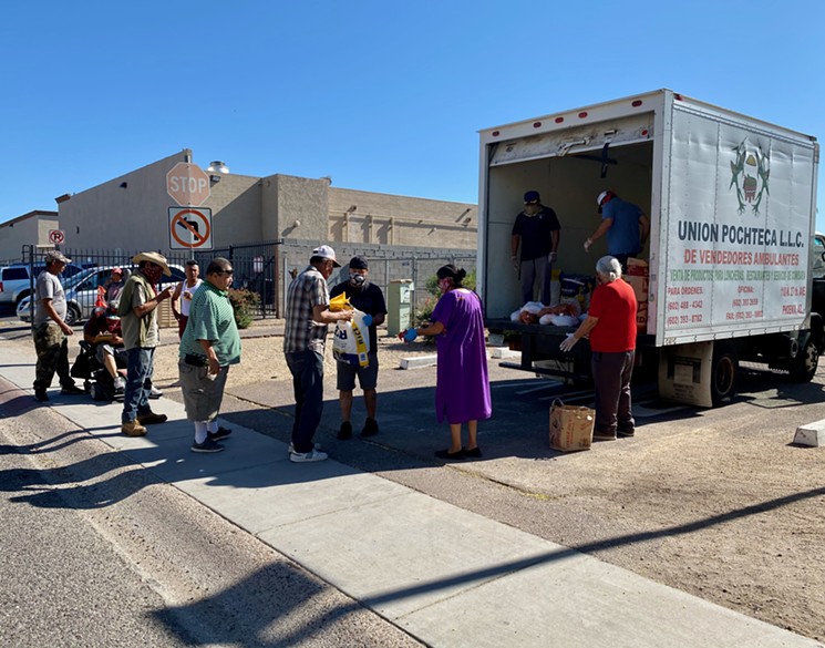 Day laborers wait in line for food supplies from Barrio Defense Committees. - KRIS VERA-PHILLIPS