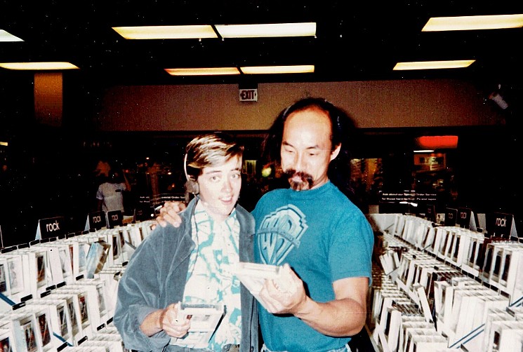 Actor Al Leong (right), who played Genghis Khan in Bill & Ted's Excellent Adventure, and crew member Connie Hoy check out tapes at Sam Goody at Metrocenter in 1987. - CONNIE HOY