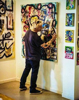 Phoenix punk rock legend Steve Davis puts the finishing touches on a piece of his artwork. - DAN BONNER