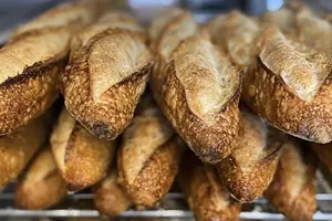 The baguette tradition, or loaves of French bread with the characteristic pointy ends. - JL PATISSERIE