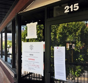 Notices from the Arizona Department of Health Services and Arizona Department of Liquor Licences and Control taped to the front door of GLOW. - BENJAMIN LEATHERMAN