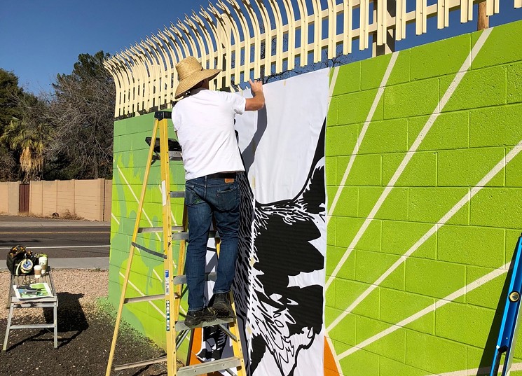 Jake Early painting a portion of Meet Me at Daley Park in Tempe. - COURTESY OF THE ARTIST.