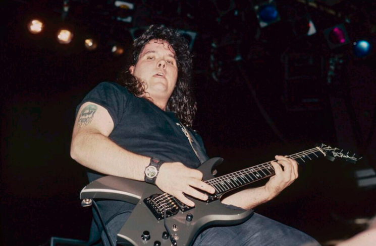 Founding member of Sacred Reich Jason Rainey onstage in the early days of the band with one of his favorite guitars. - STEPHANIE CABRAL