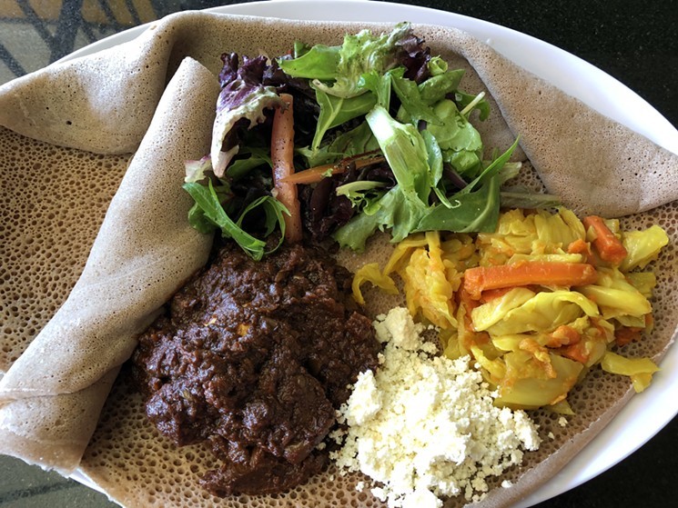 Stewed chicken and more on injera from Authentic Ethio African Spices. - CHRIS MALLOY