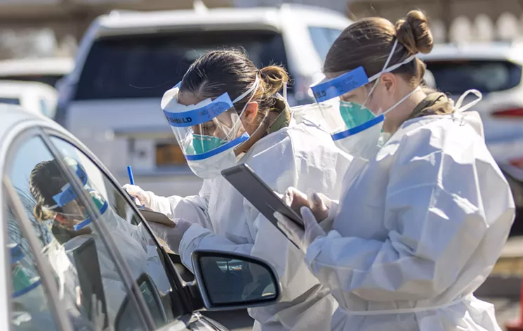 Members of the New York National Guard register people at a COVID-19 mobile testing center in New Rochelle, New York on March 14. - NEW YORK NATIONAL GUARD