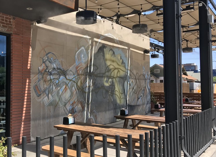 Though it seems to be increasing, murals getting defaced by graffiti is not a new problem in downtown Phoenix: El Mac and Augustine Kofie's mural on the Flowers Building in Roosevelt Row was damaged three years ago this month. - LYNN TRIMBLE