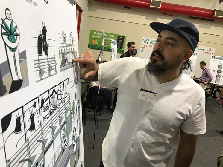 Gabriel Fortoul discussing an early Fourtoul Brothers light rail rendering during a community presentation. - LYNN TRIMBLE