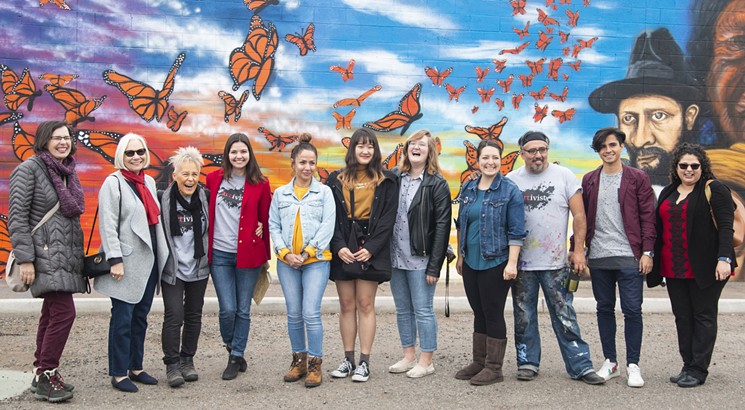 Students in the ASU Humanities Lab with a mural they painted with artist Hugo Medina. - ASU