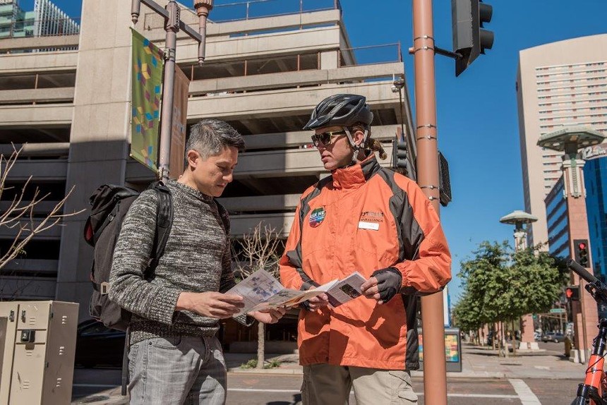 Friends, neighbors, and colleagues can hardly recall a moment when Downtown Phoenix Ambassador Hans Hughes (right) was not helping someone. Hughes was killed by a drunk driver while bicycling downtown several months ago. - DOWNTOWN PHOENIX INC.