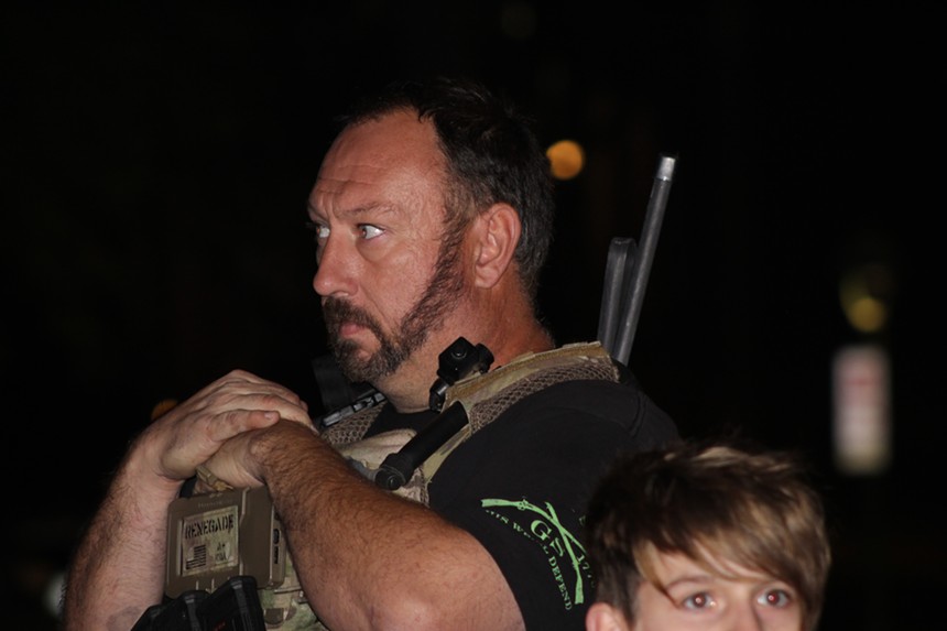 Guns and military gear were common among participants during the January 6 vigil in Phoenix. - ELIAS WEISS