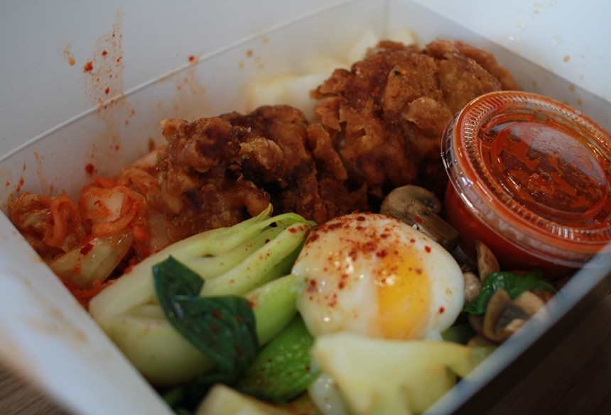 The Bap and Chicken Bowl is a bibimbap bowl with Korean fried chicken, housemade kimchi, radish, bok choy and a poached egg, served with a side of gochujang. - ALLISON TREBACZ
