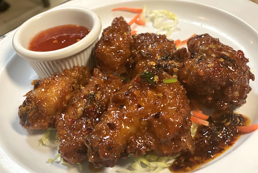 Spicy chicken wings at Pho Noodles are sauce and so worth the messy fingers. - ALLISON YOUNG