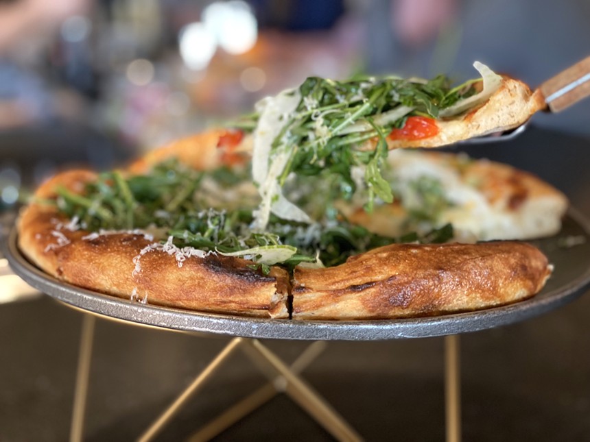 Pizza Insalata combines Fontina, Parmigiano, cherry peppers, fennel, arugula and hot honey on a puffy crust. - ALLISON YOUNG