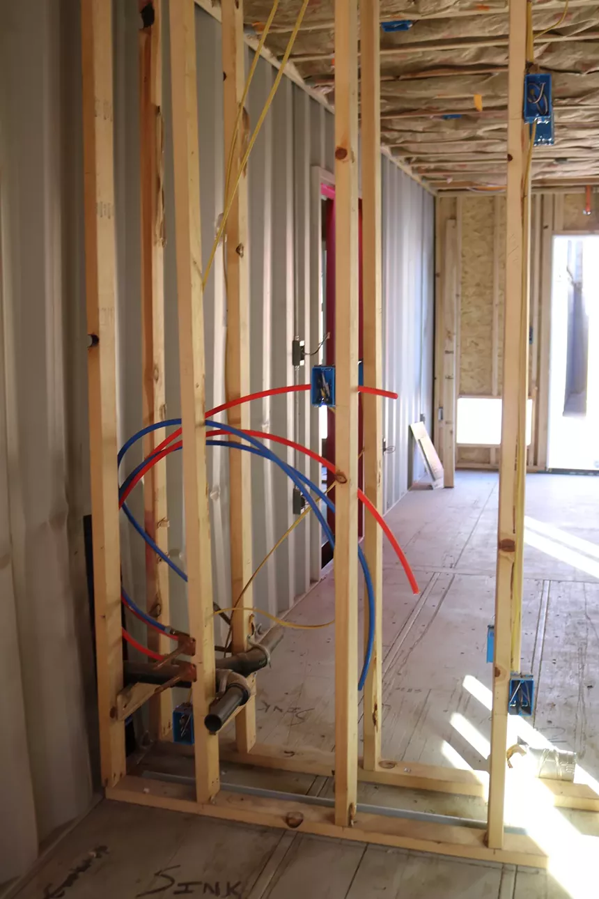 Exposed wooden frames can be seen before the walls of the tiny home apartments are built. - MIKE MADRIAGA