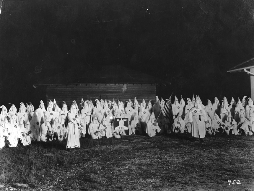 A meeting of the hooded members of the American white supremacist movement, the Ku Klux Klan, circa 1920. - HULTON ARCHIVE / GETTY IMAGES