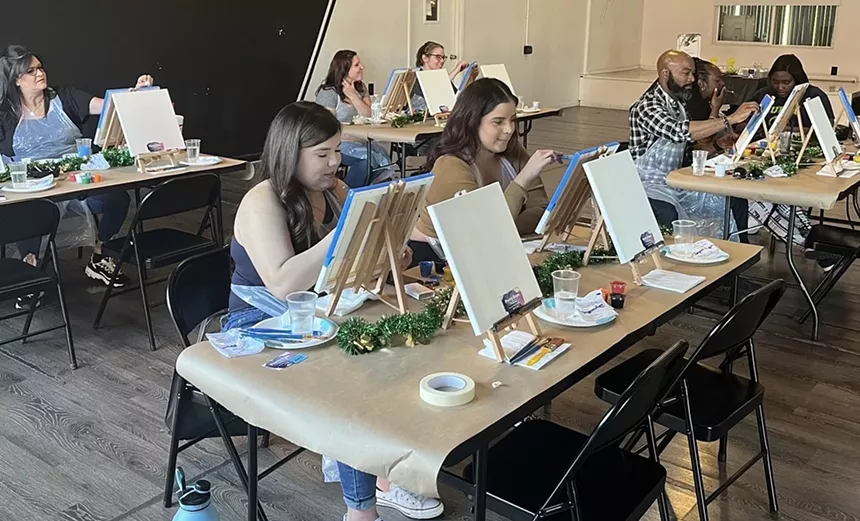 Attendees relax and create at a Pretty Dope Paintings art class. - PRETTY DOPE PAINTINGS