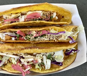 Pachamama's Tacos De Papa are stuffed with creamy garlic potatoes and crunchy slaw. - ALLISON YOUNG