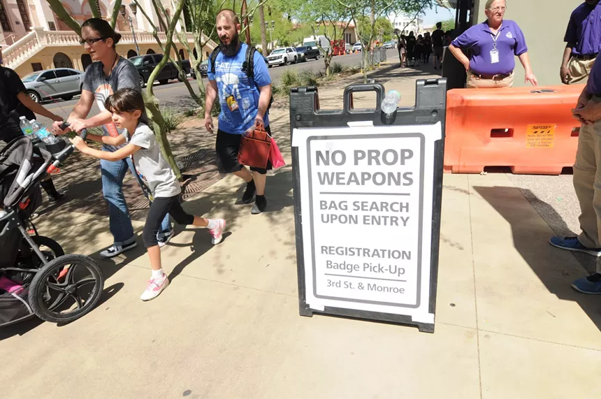 Signs advise Phoenix Comicon attendees in 2017 that all prop weapon restrictions that year. - BENJAMIN LEATHERMAN