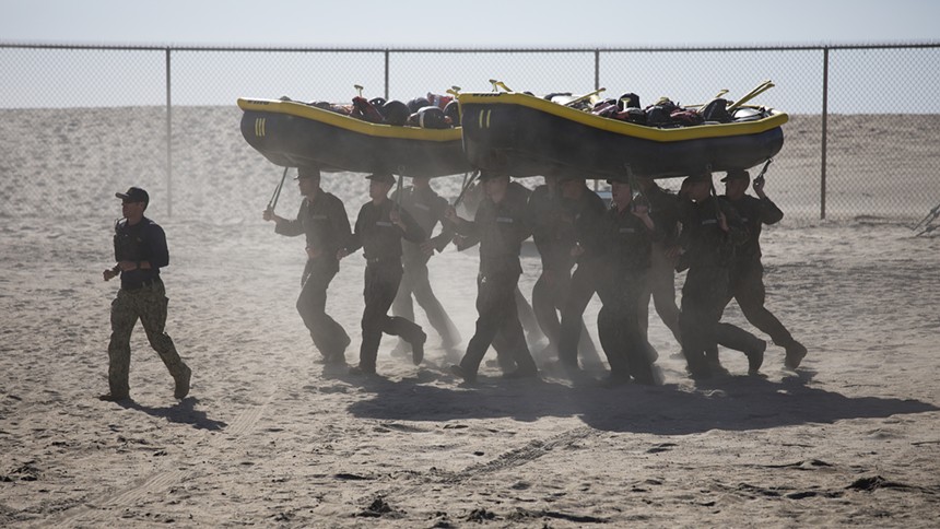 U.S. Navy SEAL candidates participate in Basic Underwater Demolition/SEAL (BUD/S) training. Brandon Caserta collapsed during the third week of training while carrying an inflatable boat. - ABE MCNATT (U.S. NAVY)
