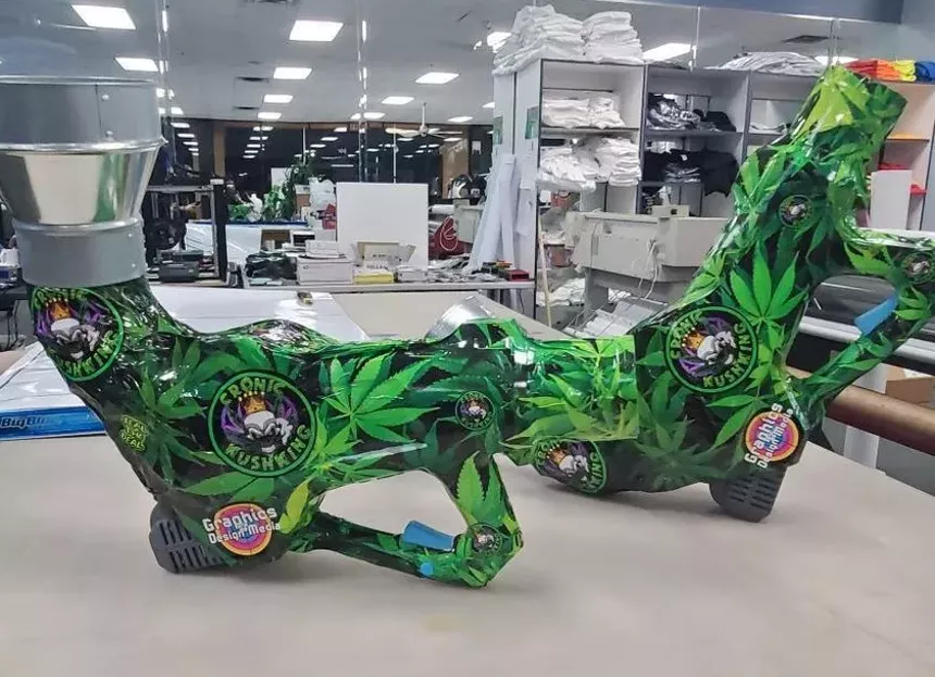 The 7-pound Kush Cannon is a black- and neon green-colored smoke thrower that resembles a post-apocalyptic bazooka in an anime flick. - CRONIC KUSH KING